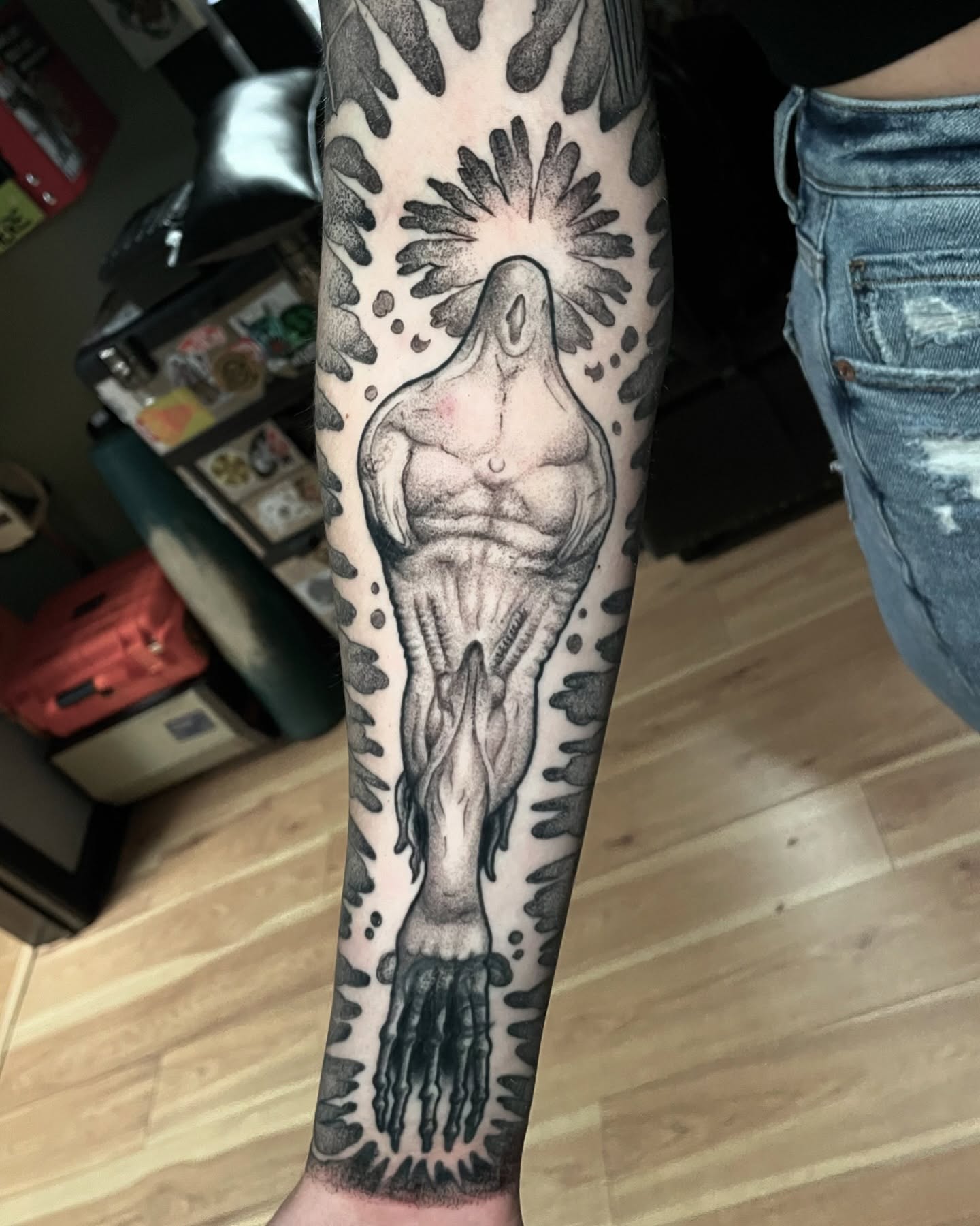 Muscular figure dotwork tattoo on the forearm by Ian Spong