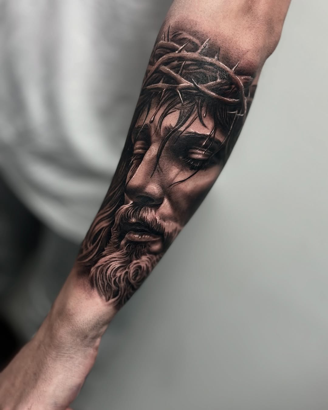 Jesus Christ portrait Chicano tattoo on the forearm by Aaron Watson