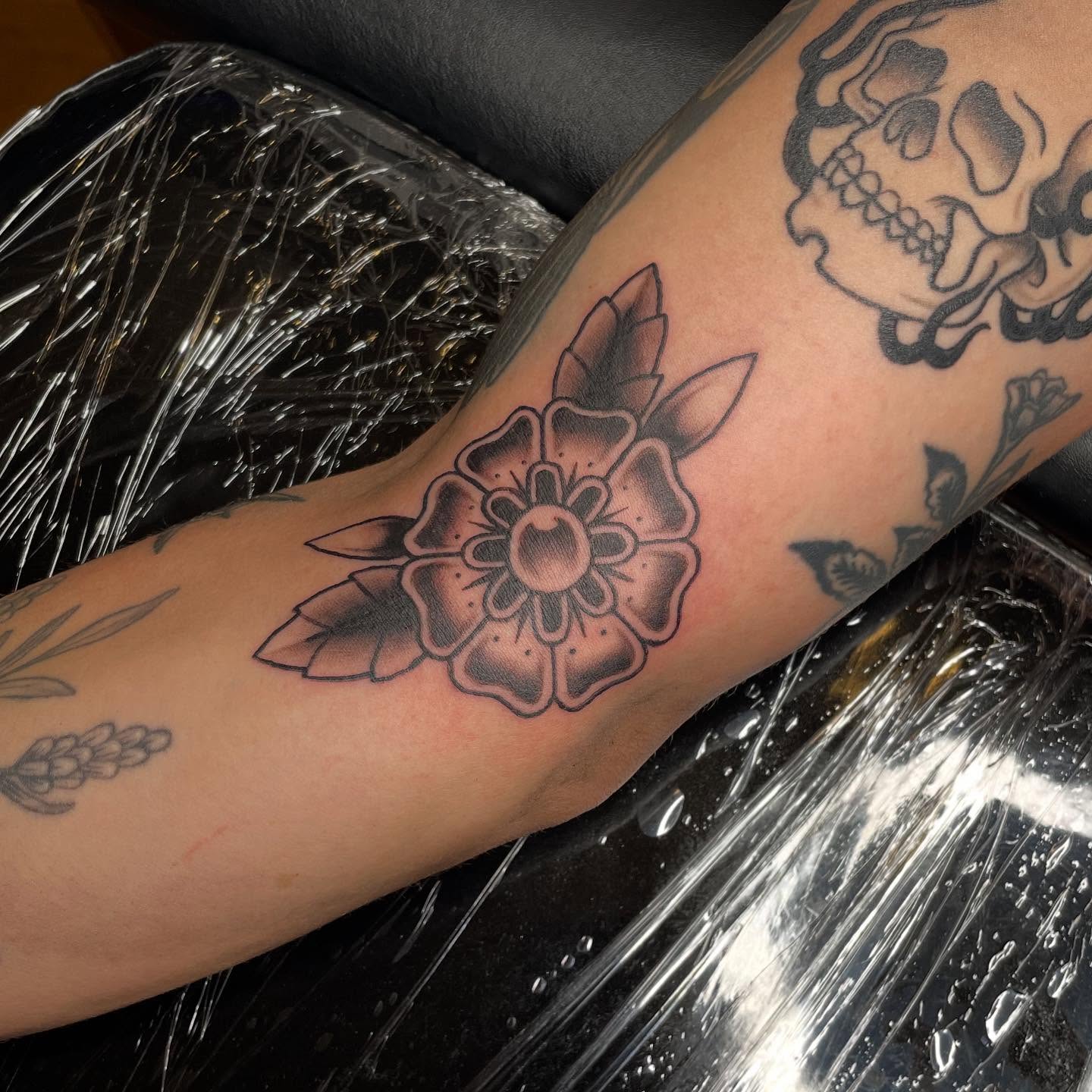 Flower American traditional tattoo on the forearm by Alex Larsen