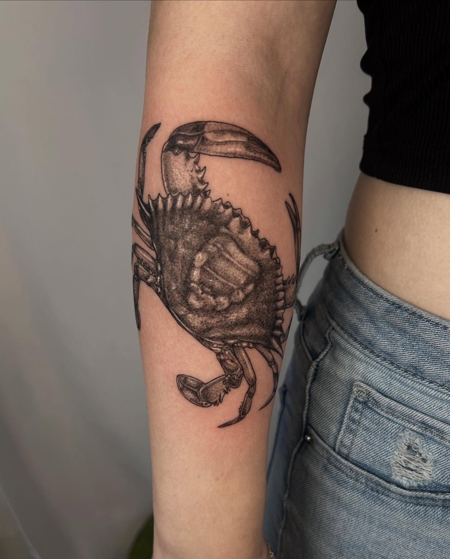 Crab black and grey tattoo on the forearm by Nikki Power