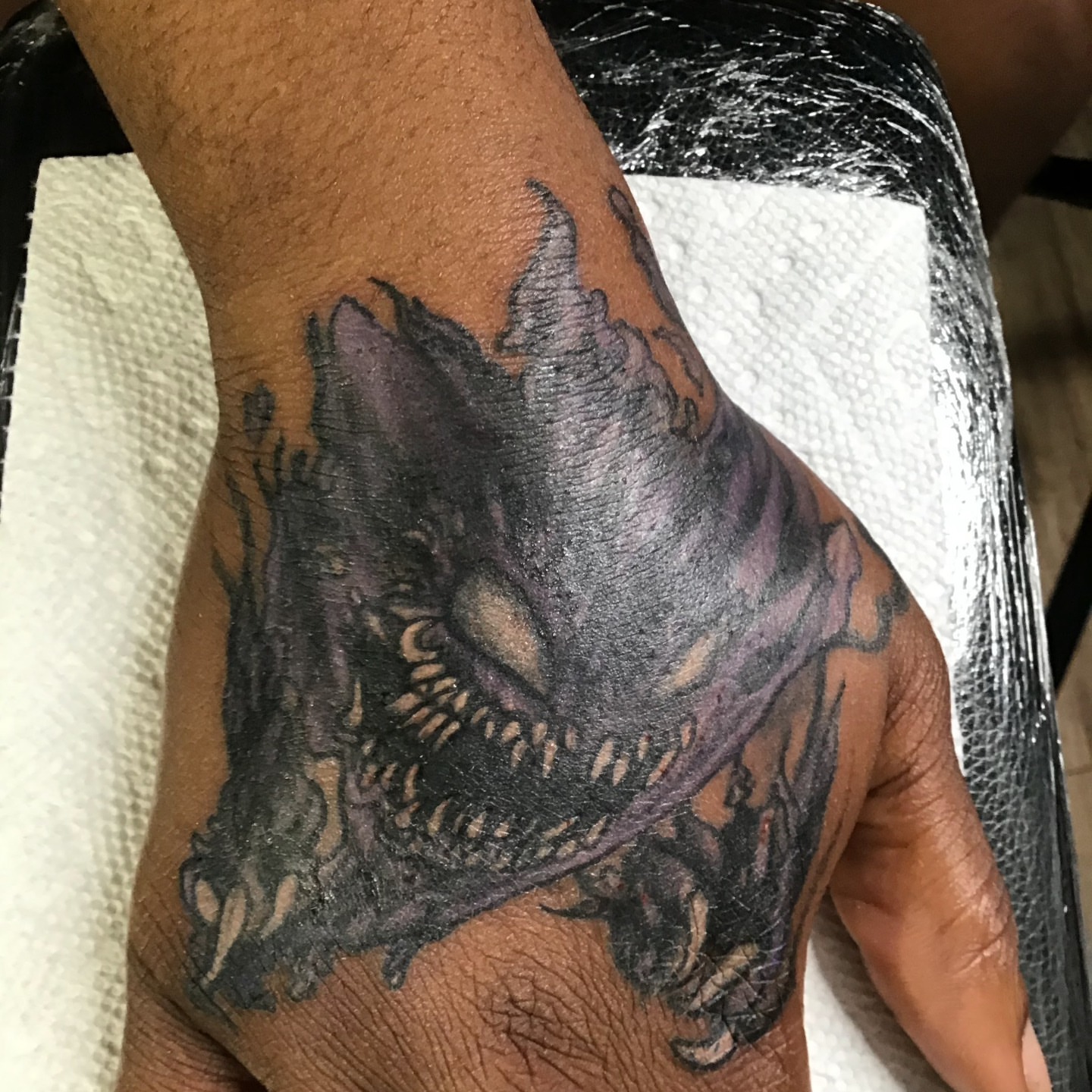 Demon dark realism tattoo on the forearm by Gabriel Lawton