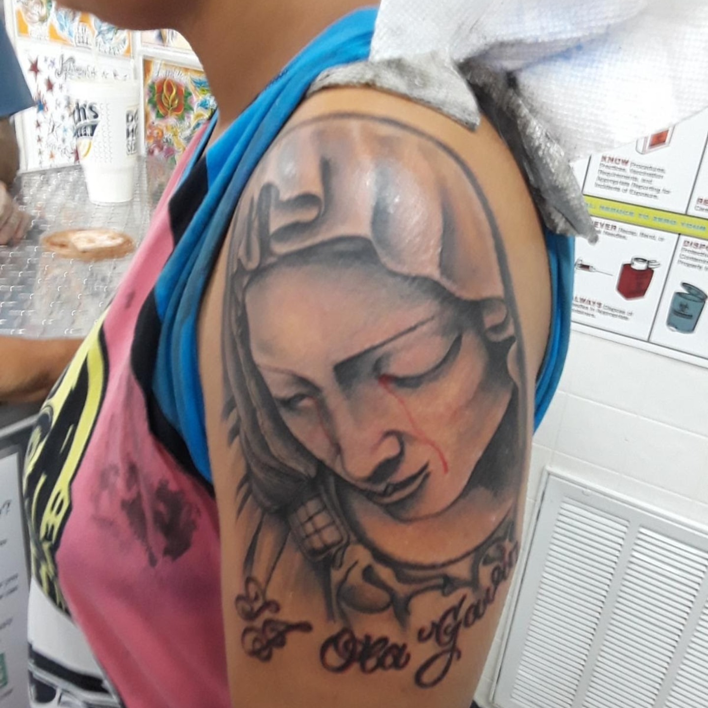 Woman with tears realism tattoo on the shoulder by Gabriel Lawton