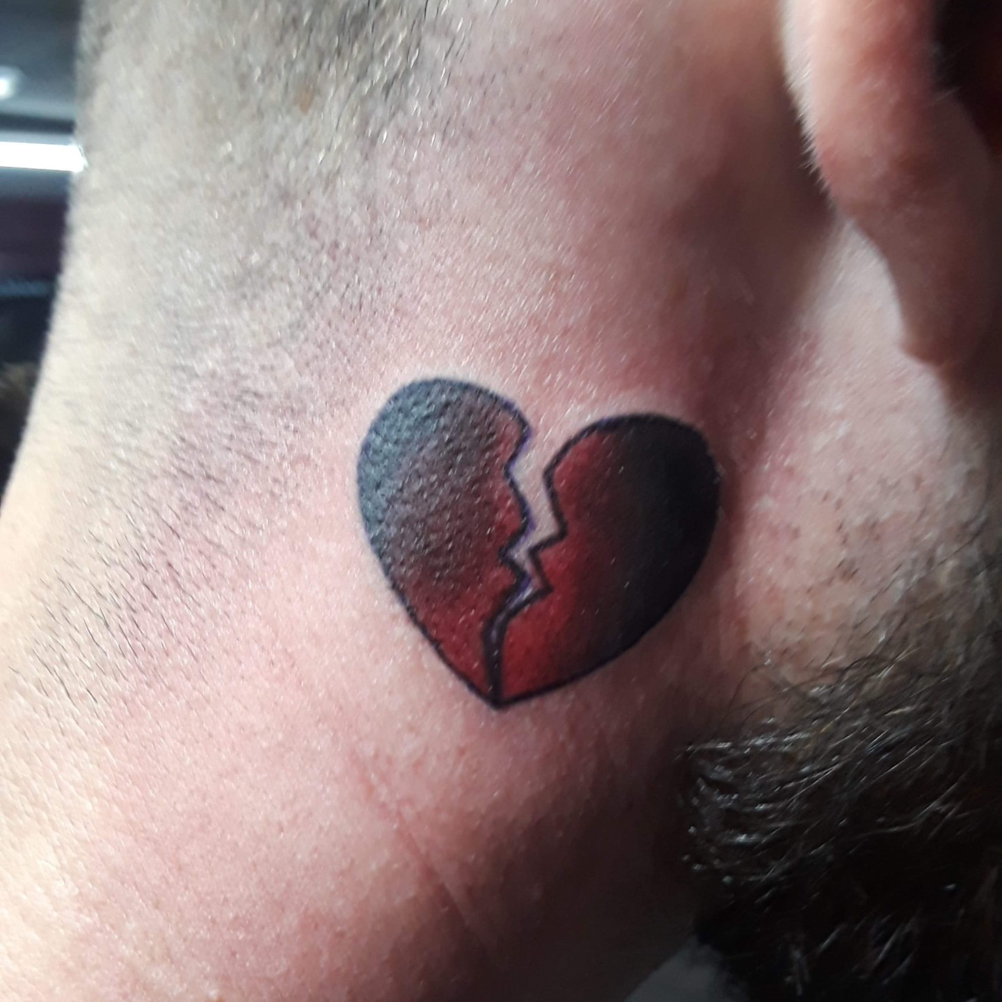 Broken heart black and grey tattoo on the neck by Gabriel Lawton
