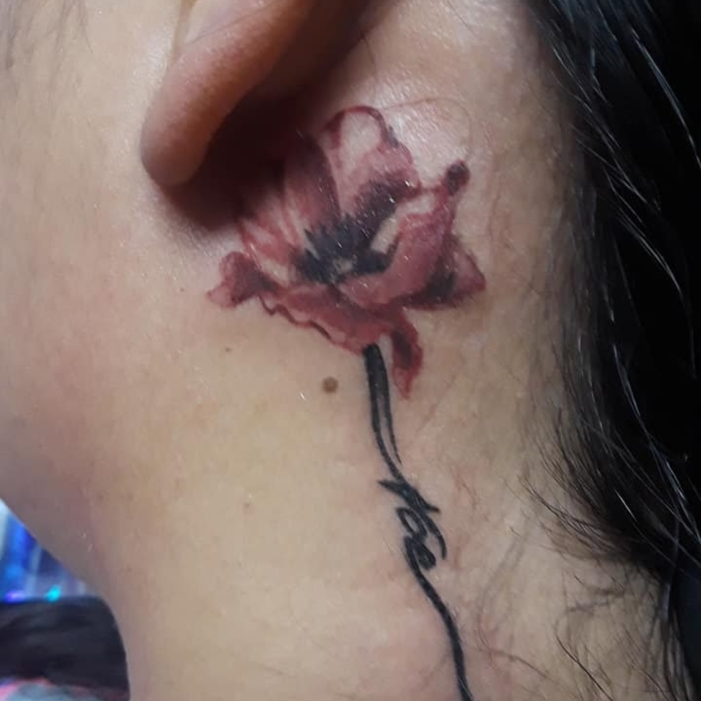 Flower dotwork tattoo on the neck by Gabriel Lawton