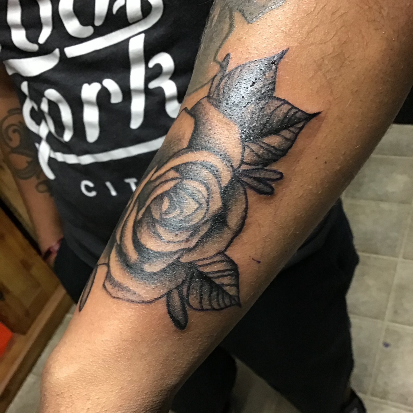 Rose black and grey tattoo on the forearm by Gabriel Lawton