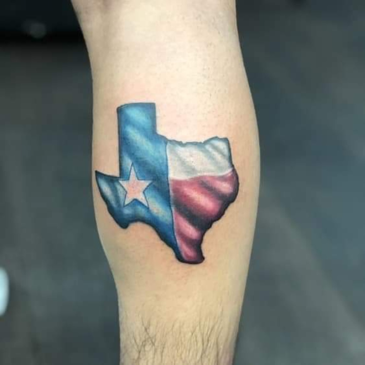 Texas state outline with flag American traditional tattoo on the forearm by Gabriel Lawton