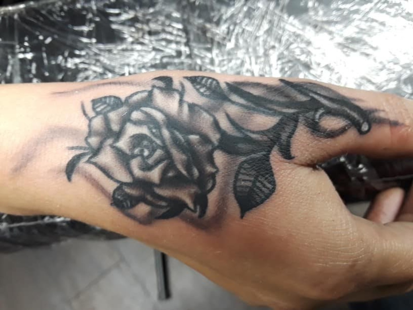 Rose black and grey tattoo on the hand by Gabriel Lawton