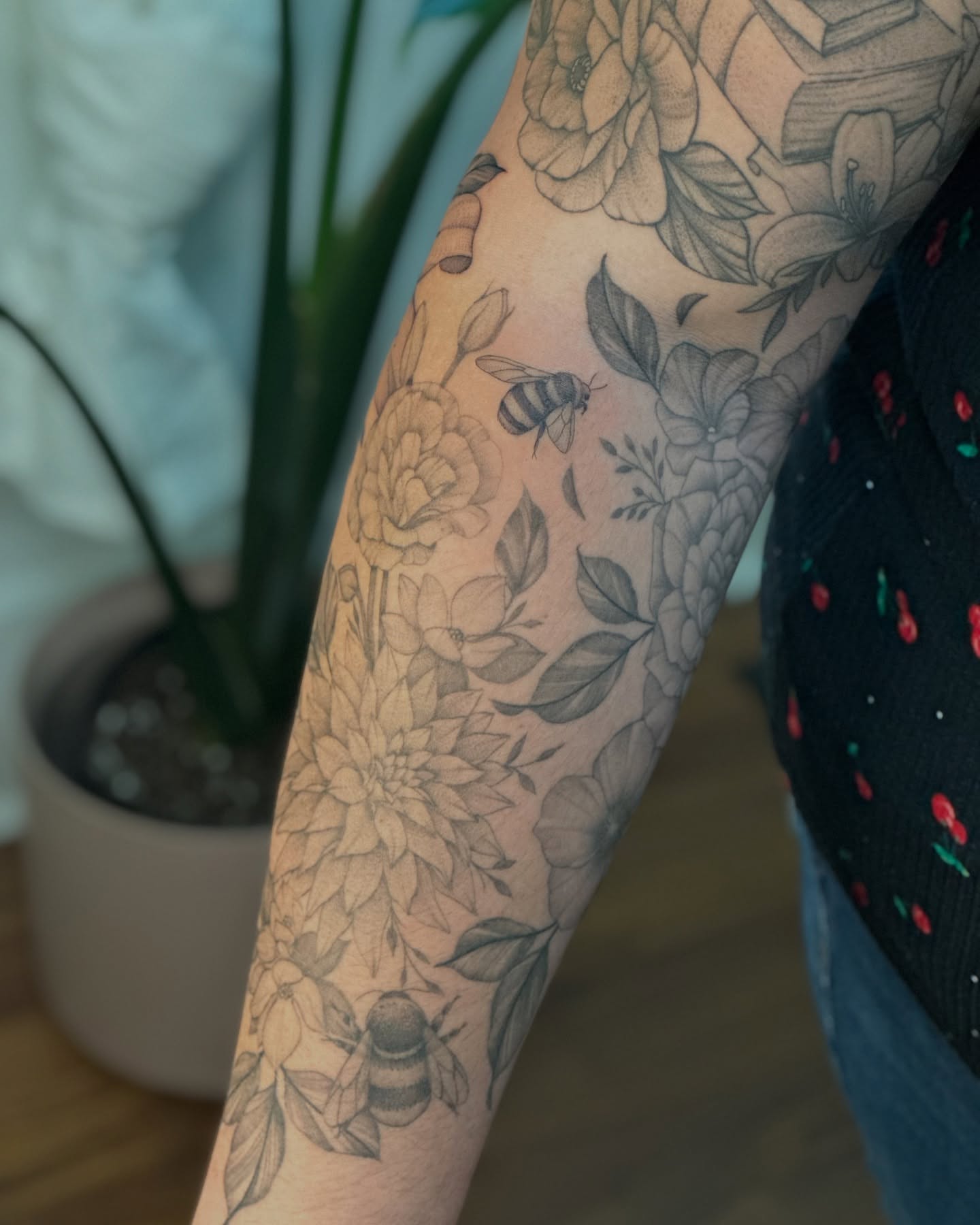 Floral pattern with bees black and grey tattoo on the forearm by ๐
๐๐๐๐๐ ๐๐๐๐๐๐