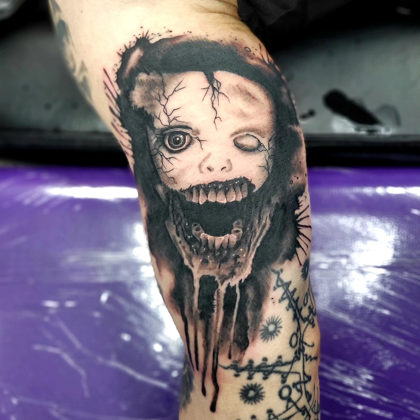 Horror creature dark realism tattoo on the forearm by Jentrey McCausland