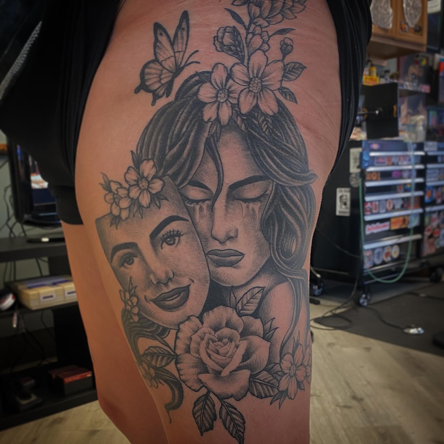Woman's face with flowers realism tattoo on the thigh by Kyle Mitchell, Cincinnati
