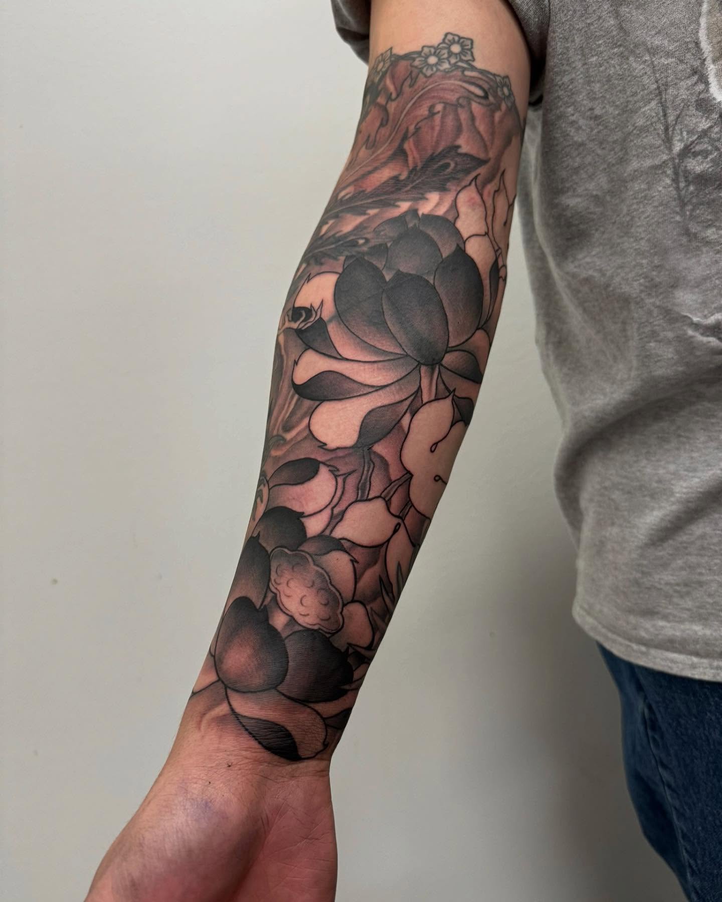 Lotus flowers realism tattoo on the forearm by Sam Oakes
