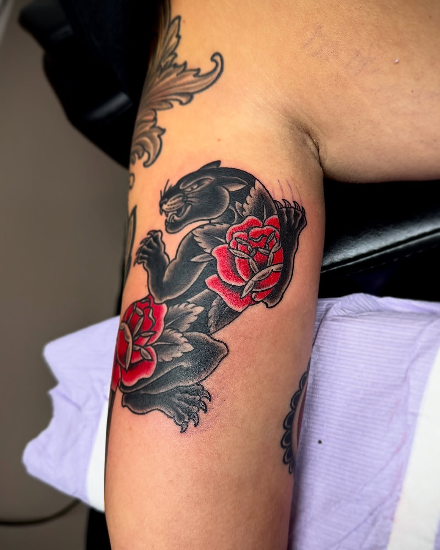 Panther and roses American traditional tattoo on the forearm by Derek Cilla, Bethlehem, Pennsylvania