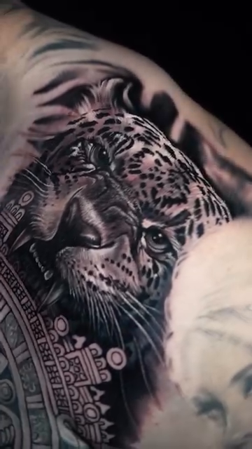 Jaguar and Aztec calendar realism tattoo by Duniel Garcia