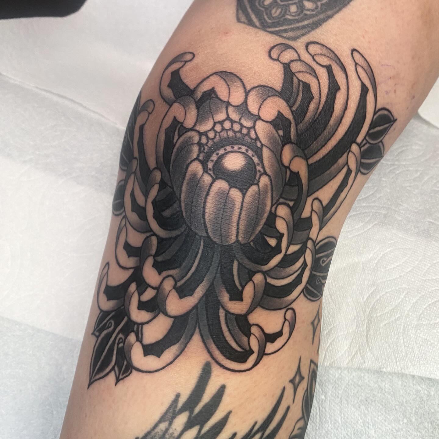 Chrysanthemum geometric tattoo on the forearm by Lindsey Cam Van