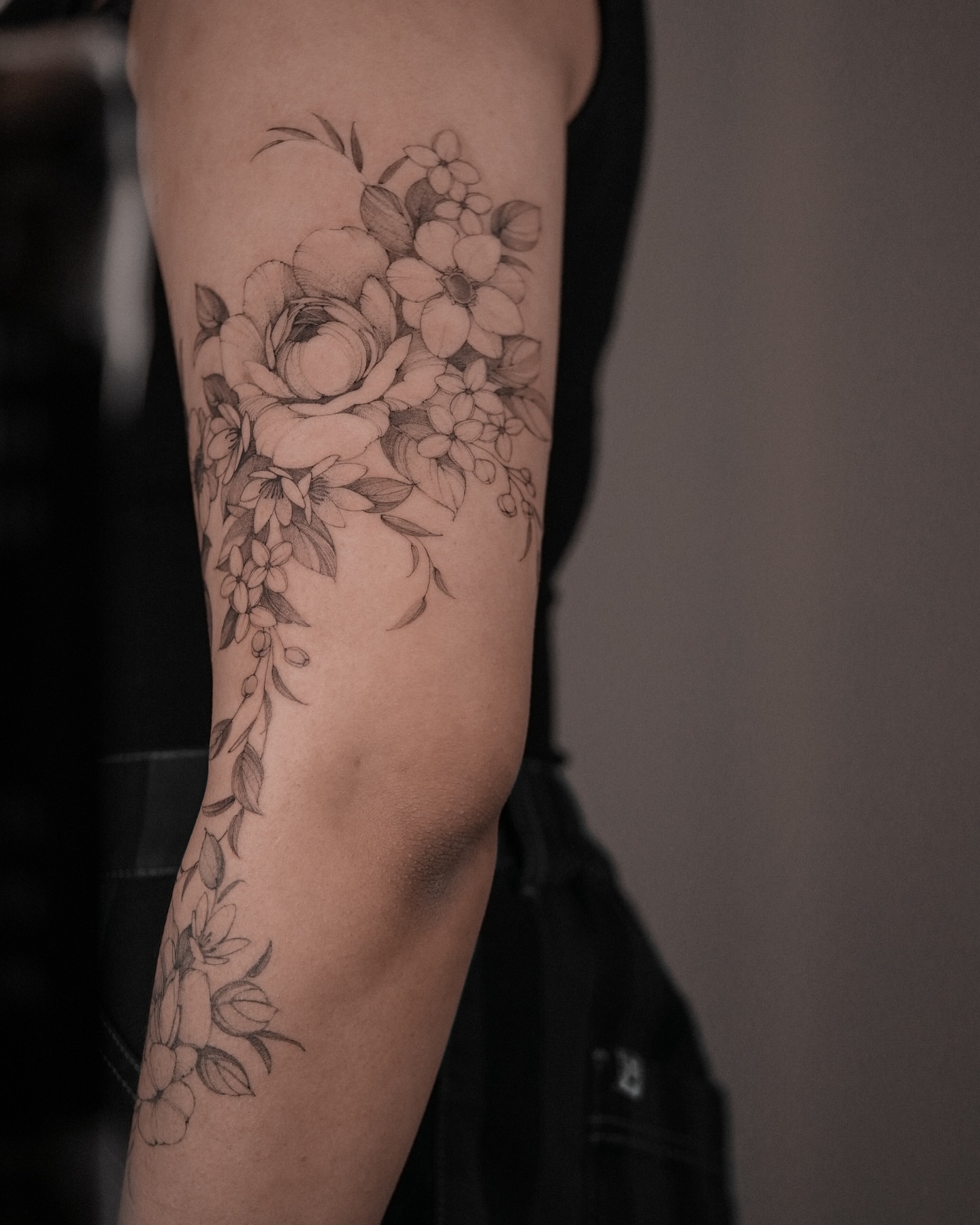 Floral bouquet black and grey tattoo on the forearm by Mary Shekh