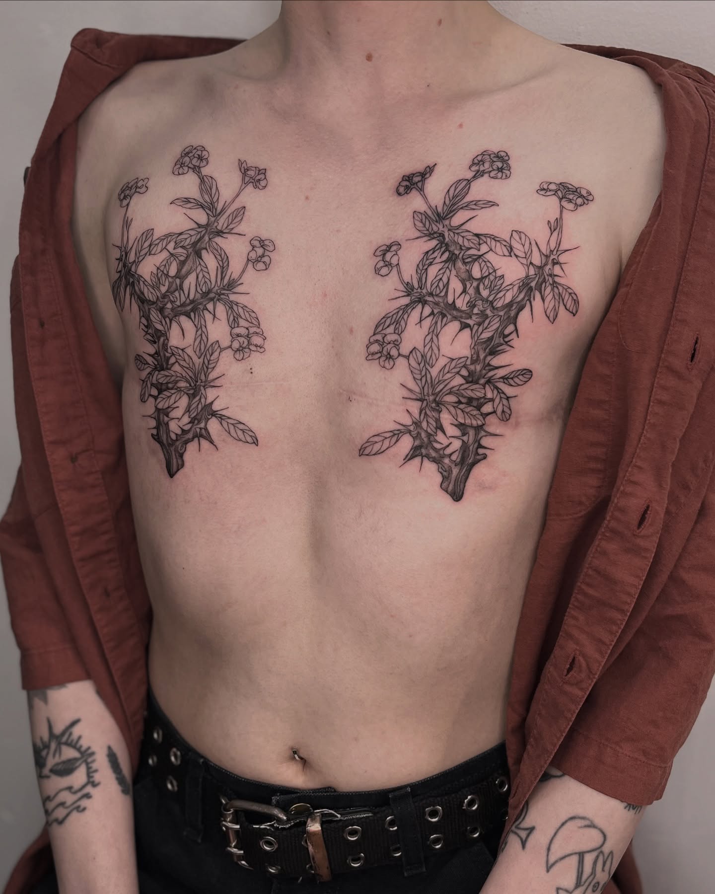 Botanical black and grey tattoo on the chest by Ying Xeon