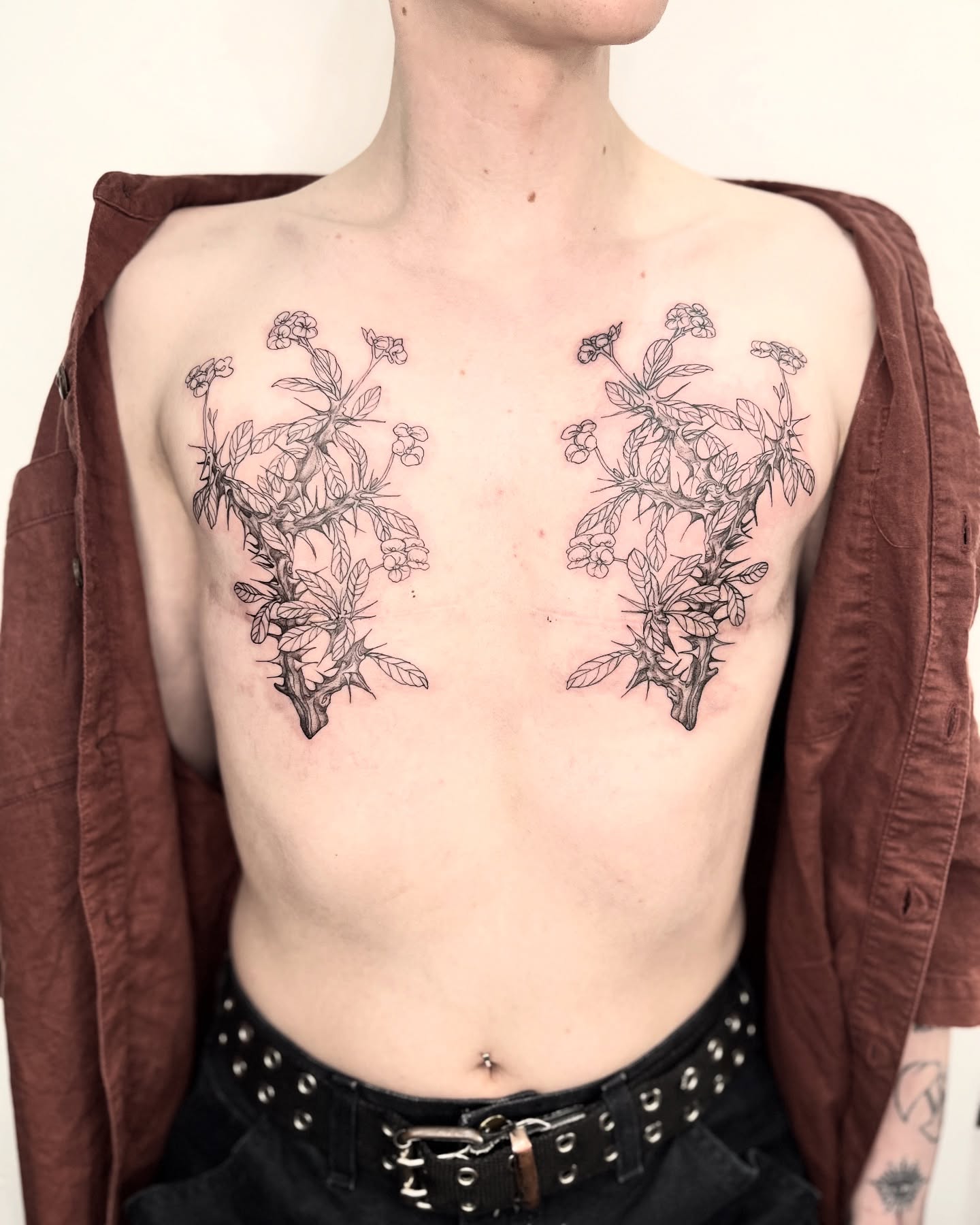 Botanical black and grey tattoo on the chest by Ying Xeon
