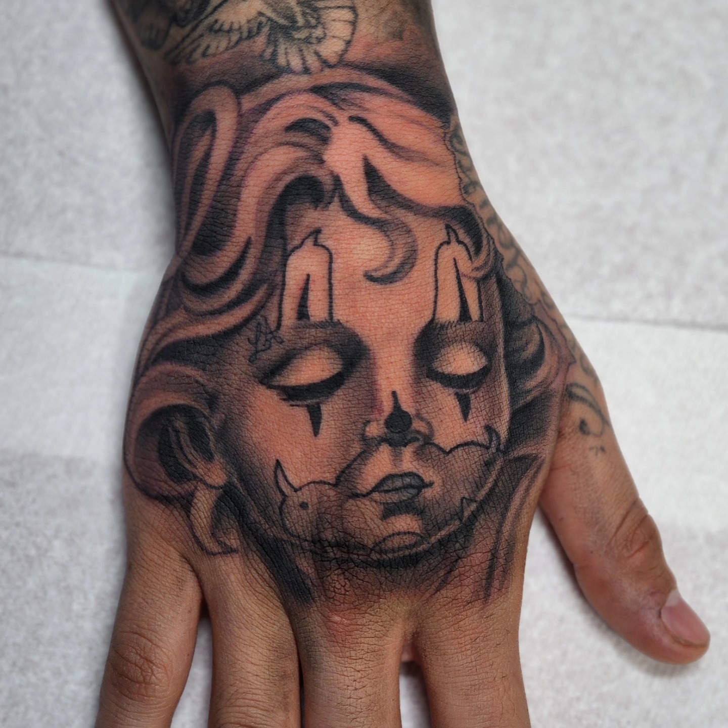 Doll head American traditional tattoo on the hand by @tattoobytats