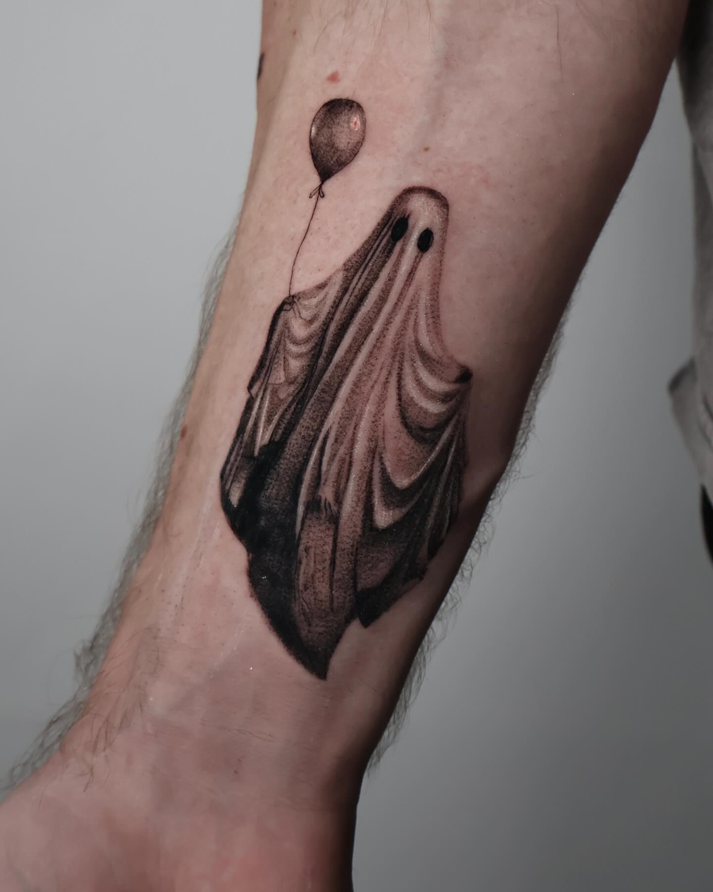 Ghost with balloon dotwork tattoo on the forearm by Stephanie Pedraza