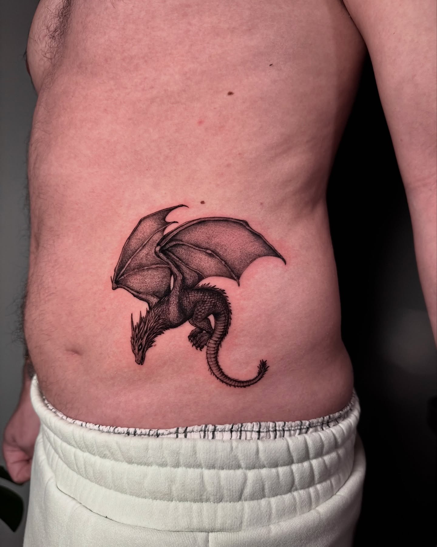 Dragon dotwork tattoo on the ribs by Ninna