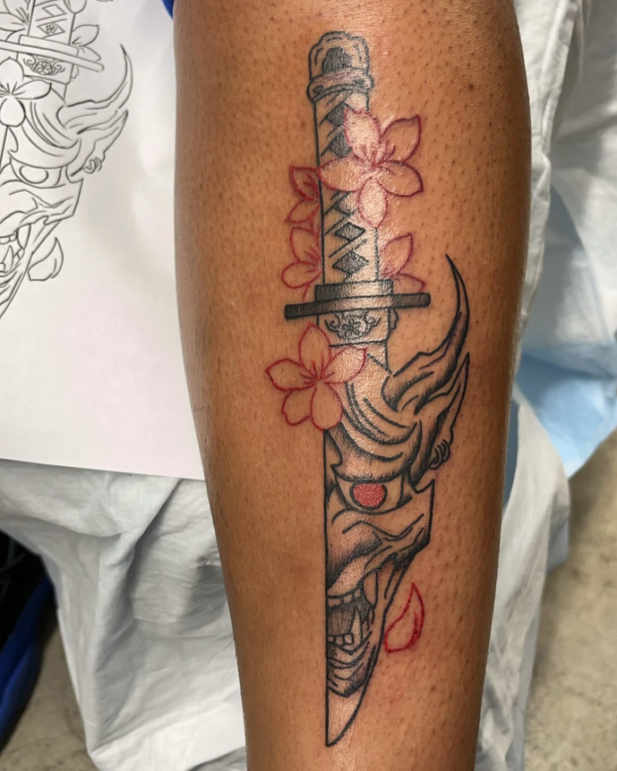 Katana and cherry blossoms japanese irezumi tattoo on the forearm by Alesia