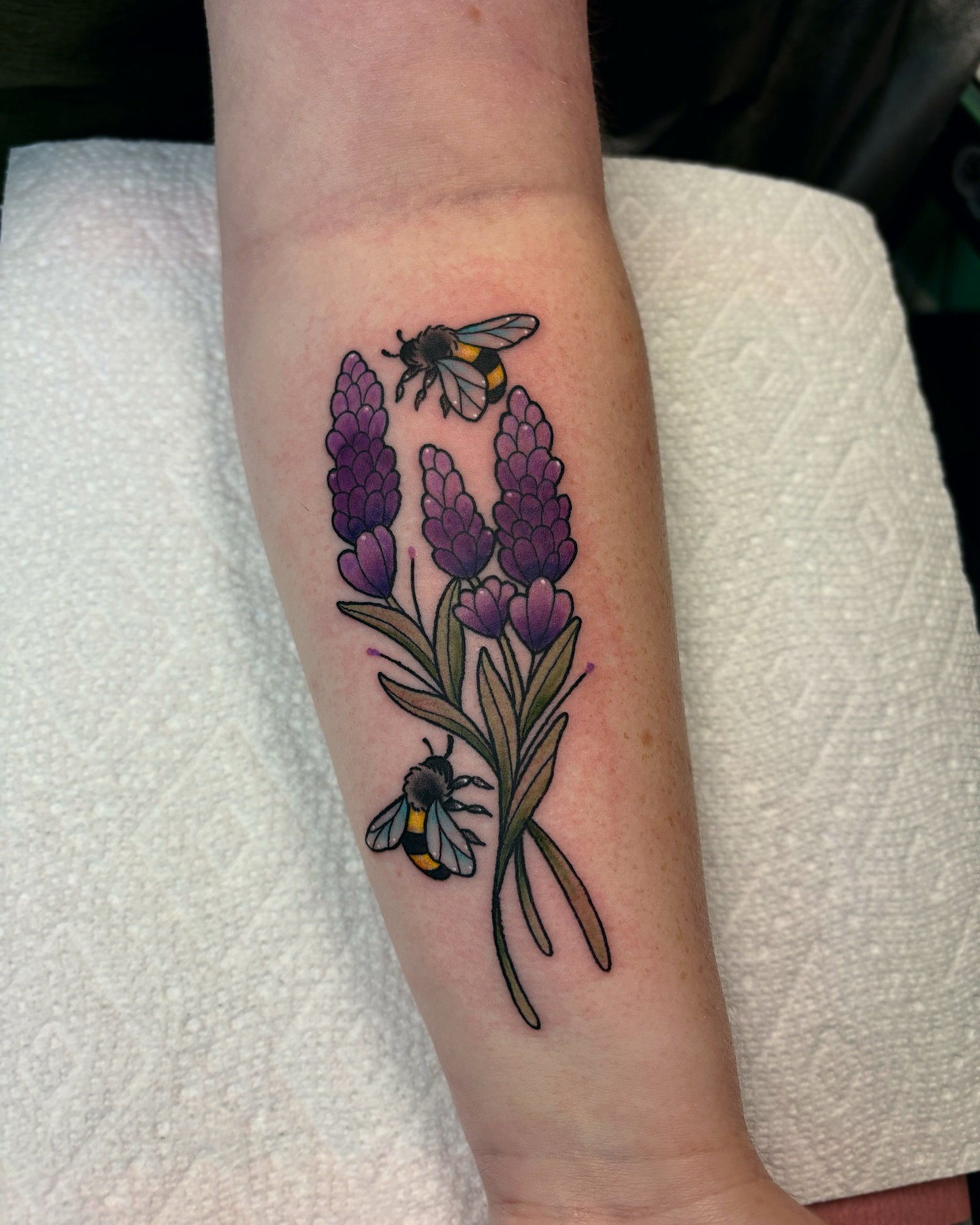Lavender and bees realism tattoo on the forearm by Bunny Noel