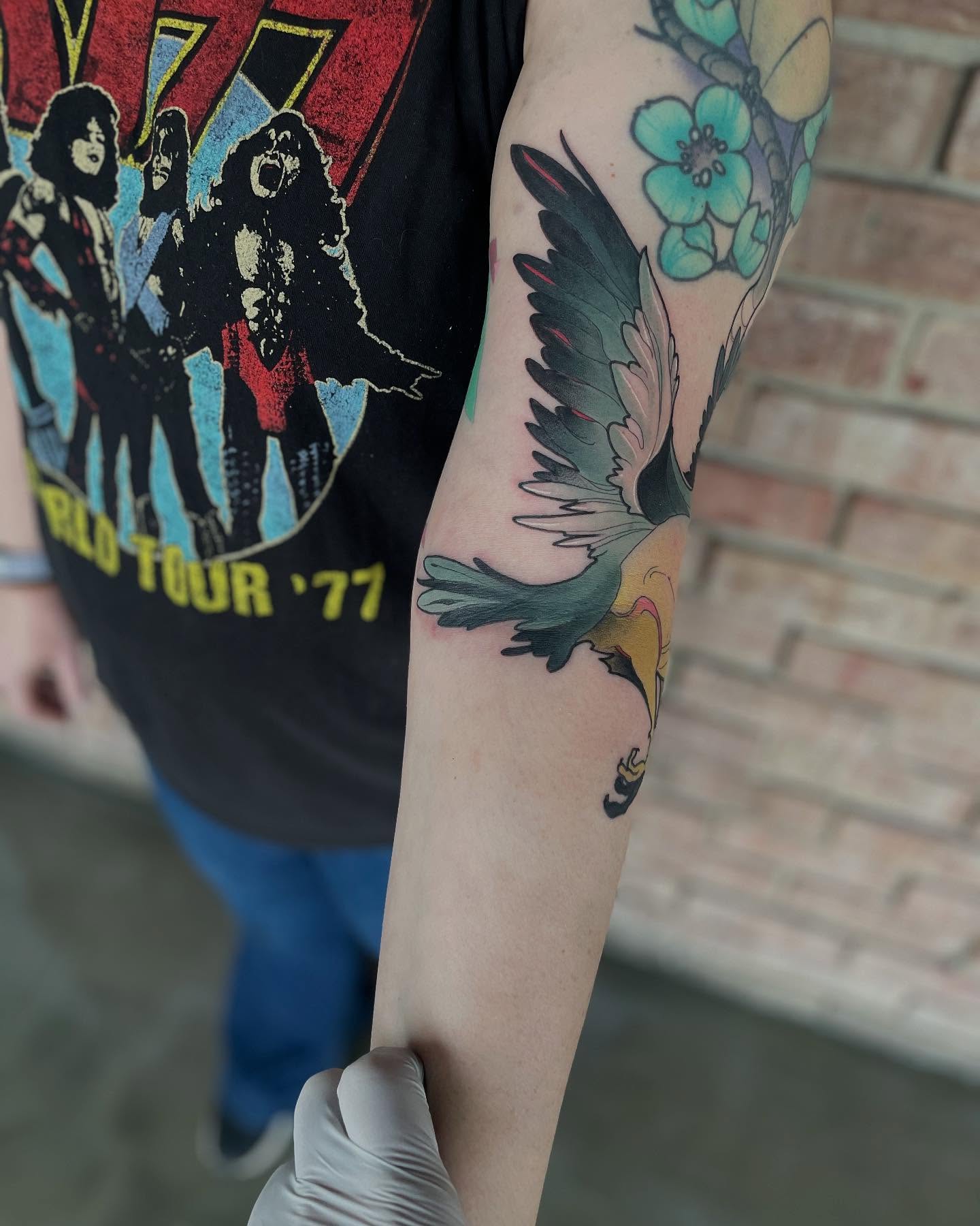 Bird and flowers dotwork tattoo on the forearm by Nathan Evans