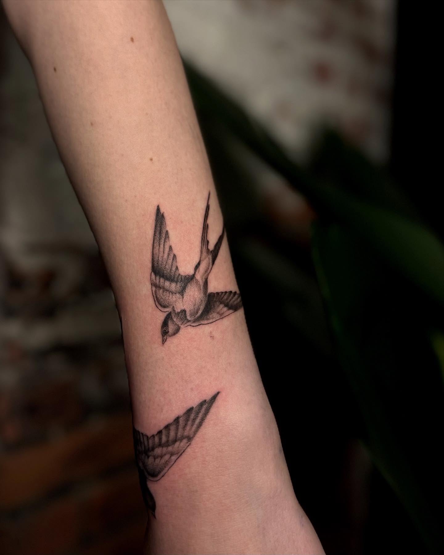 Swallow black and grey tattoo on the forearm by Isabel Smith🦋🕷️