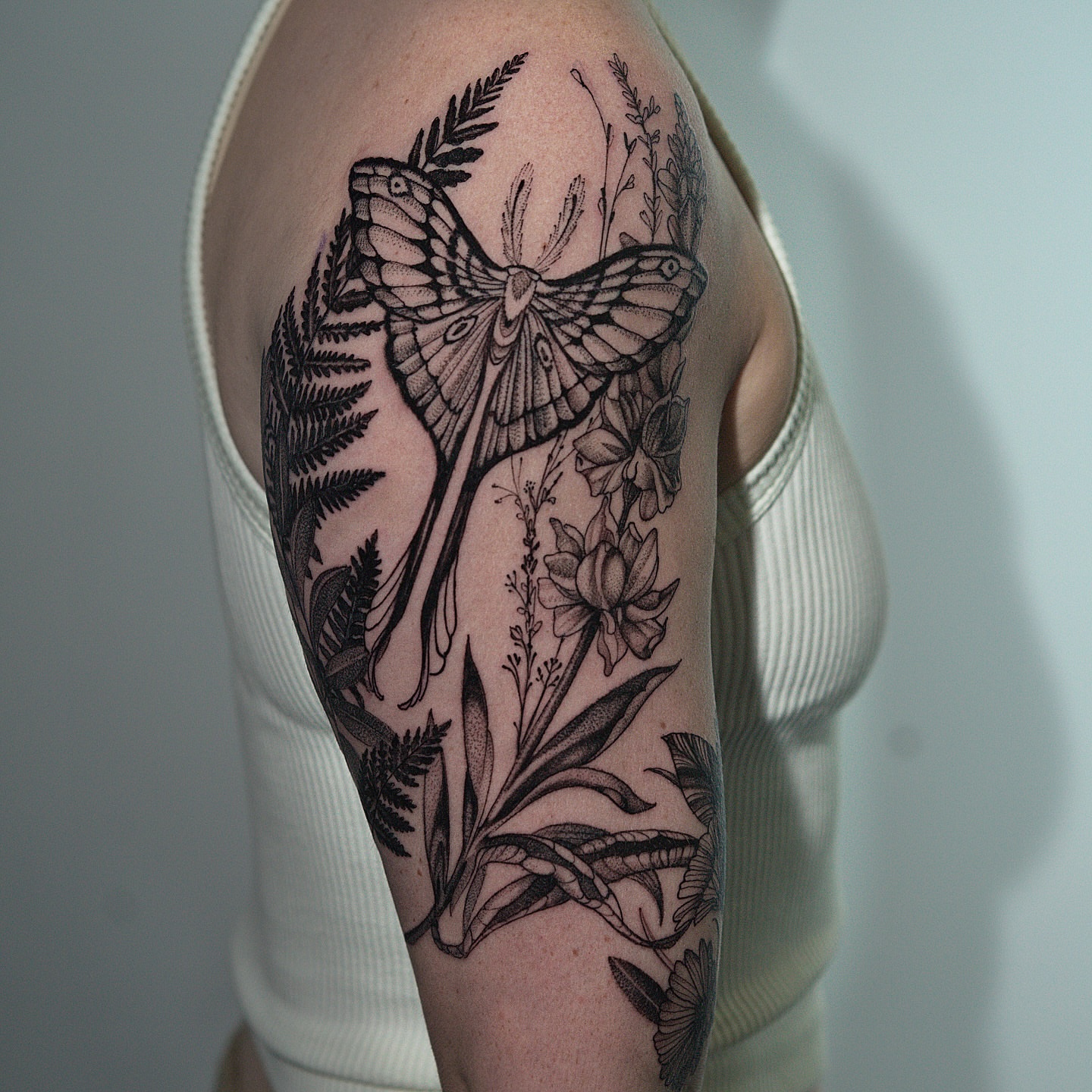 Butterfly and flowers realism tattoo on the forearm by H I R A  L U P E - tattoo artist, Oakland, California