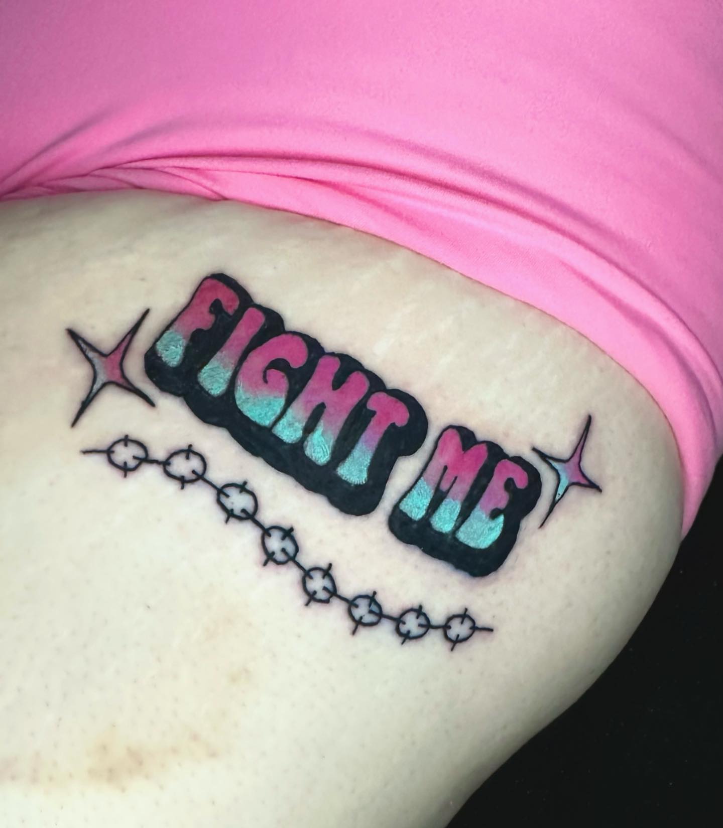 Fight me lettering script tattoo on the thigh by Brooke
