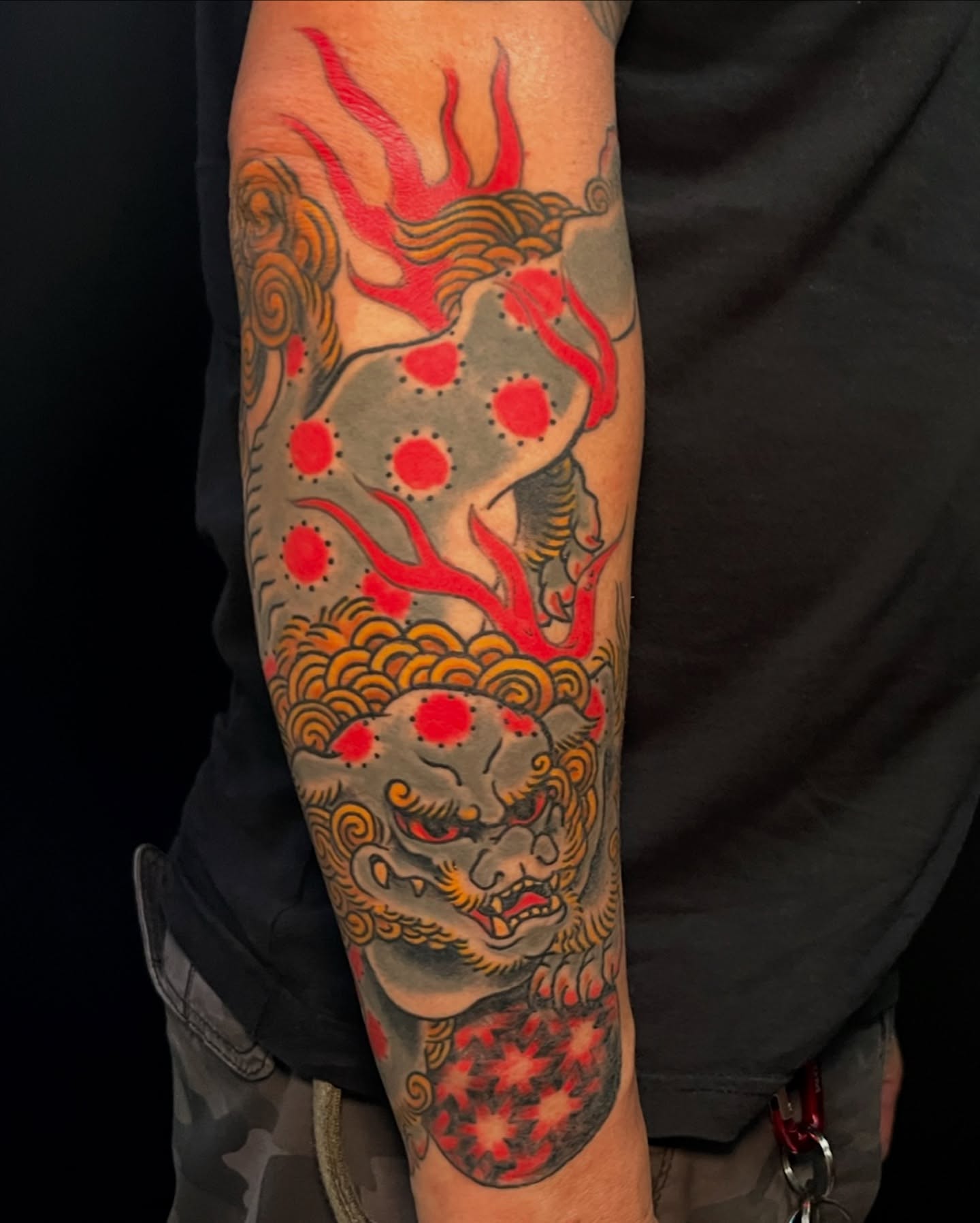 Lion with flames japanese irezumi tattoo on the forearm by Andrew Snowden