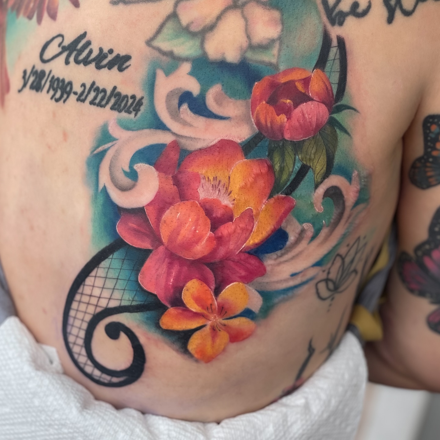 Floral arrangement watercolor tattoo on the chest by Erica Olivier
