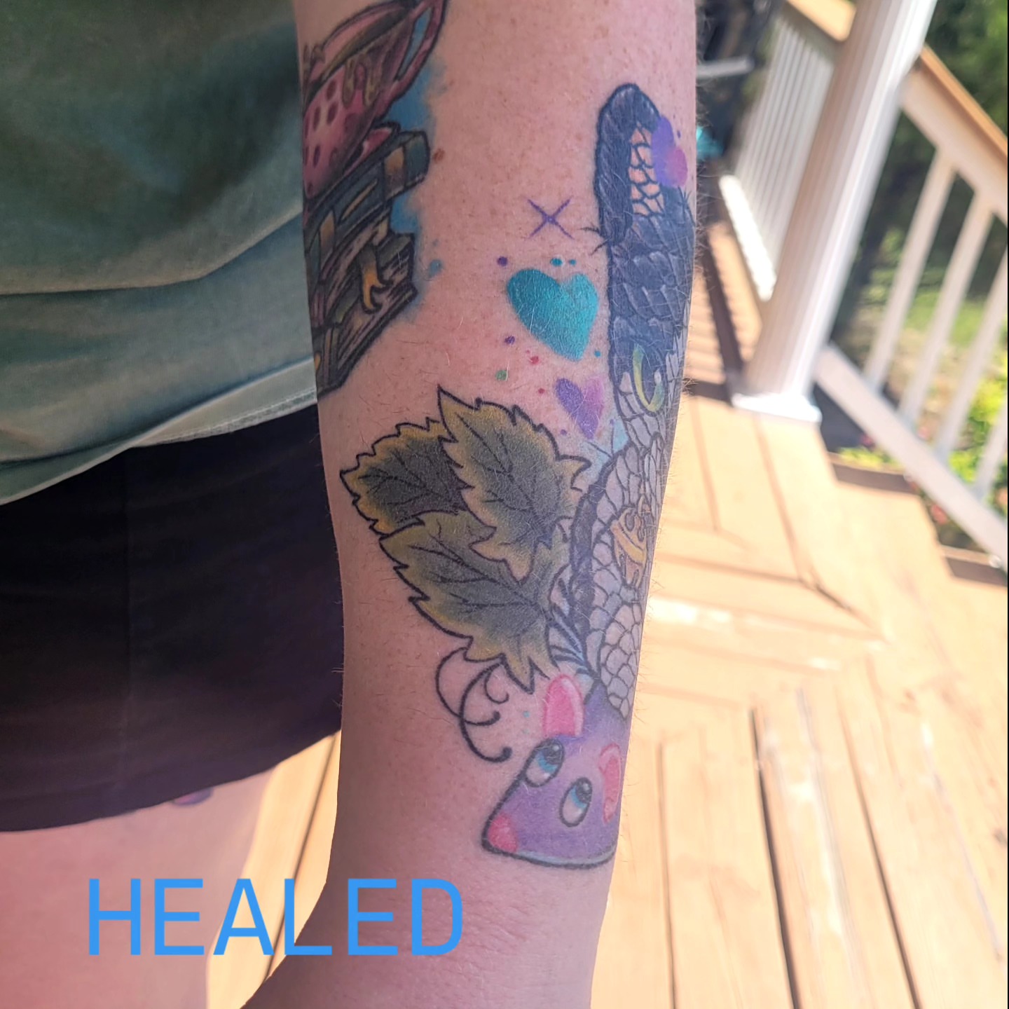 Tea cup and butterfly watercolor tattoo on the forearm by Dawne Michele