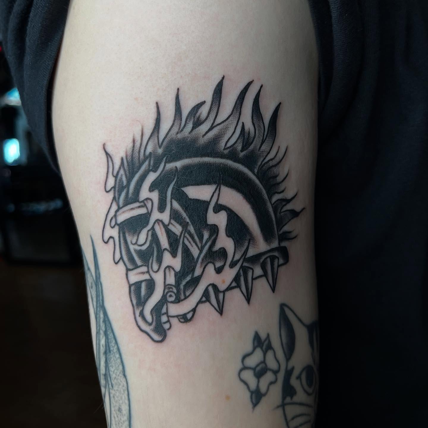 Flaming dragon black and grey tattoo on the forearm by Mariah Nguyen