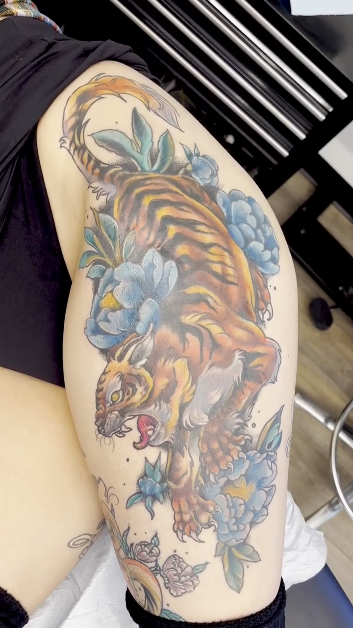Tiger with peonies Japanese tattoo on the shoulder by Cricket Elijah Cervidae