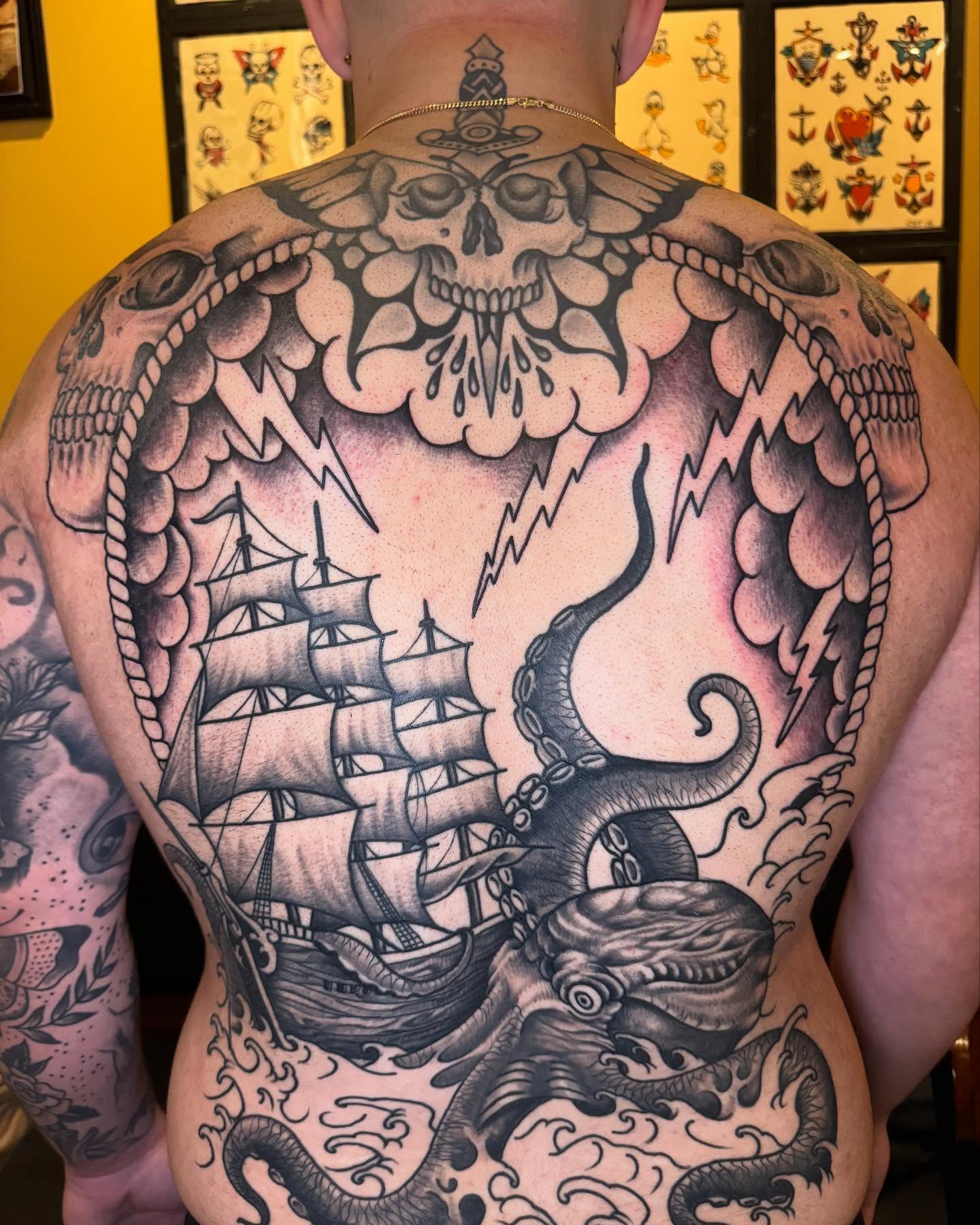 Ship and octopus American traditional tattoo on the back by Rob Keiuf