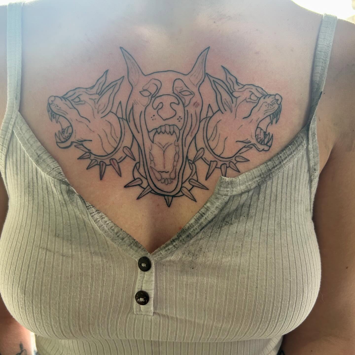 Three dogs black and grey tattoo on the chest by Haley Winfree