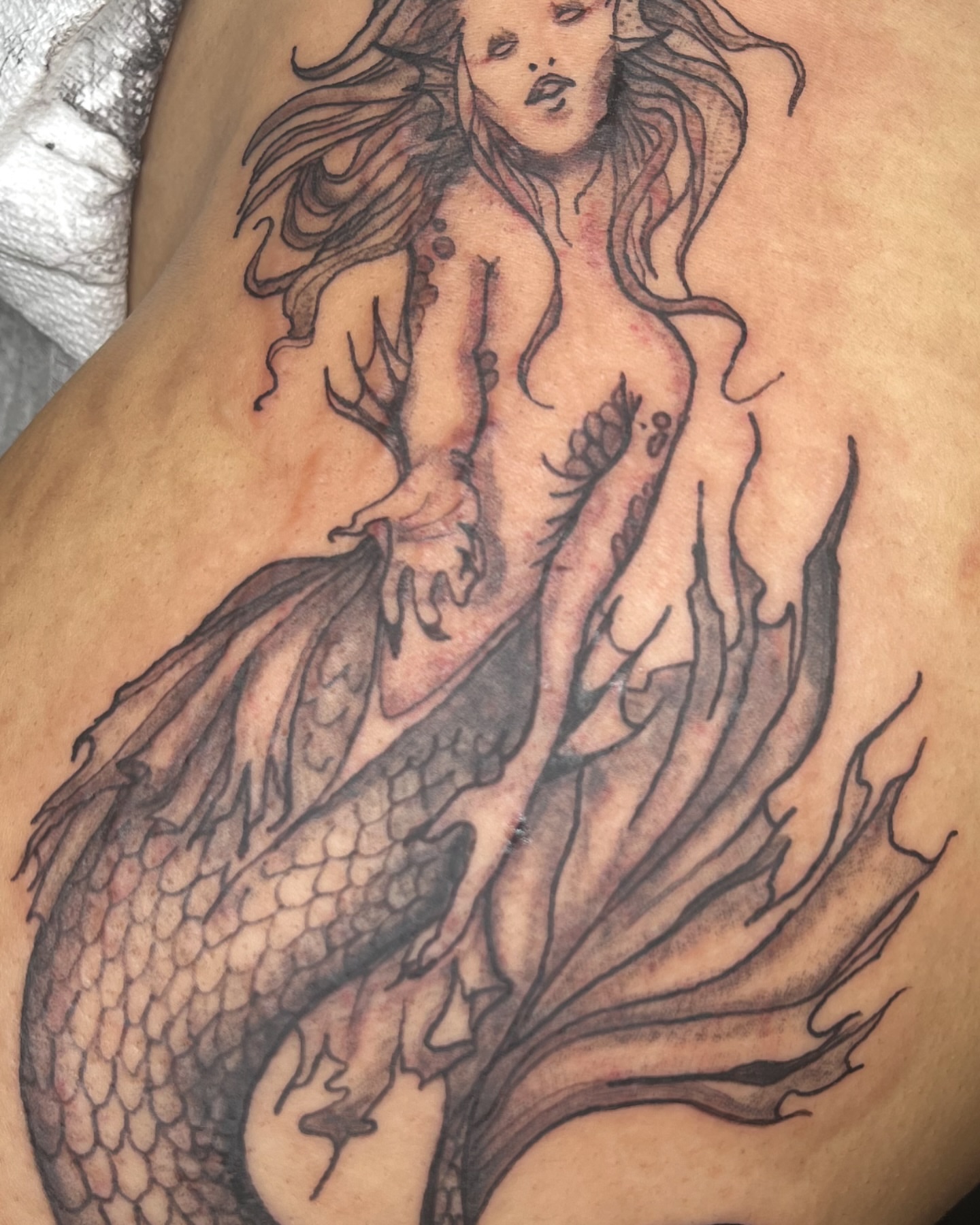 Mermaid black and grey tattoo on the thigh by Eddie Cesena