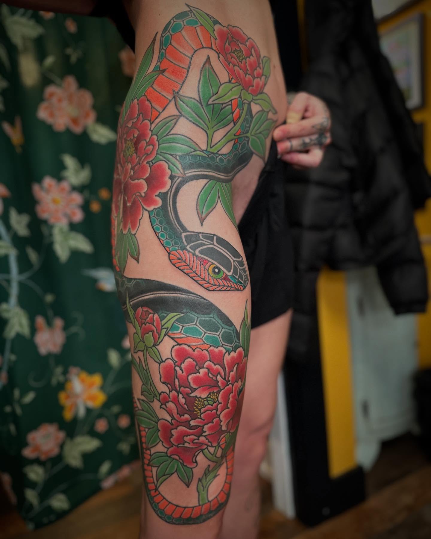 Snake and peony American traditional tattoo on the calf by Megon Shore, Seattle, Washington