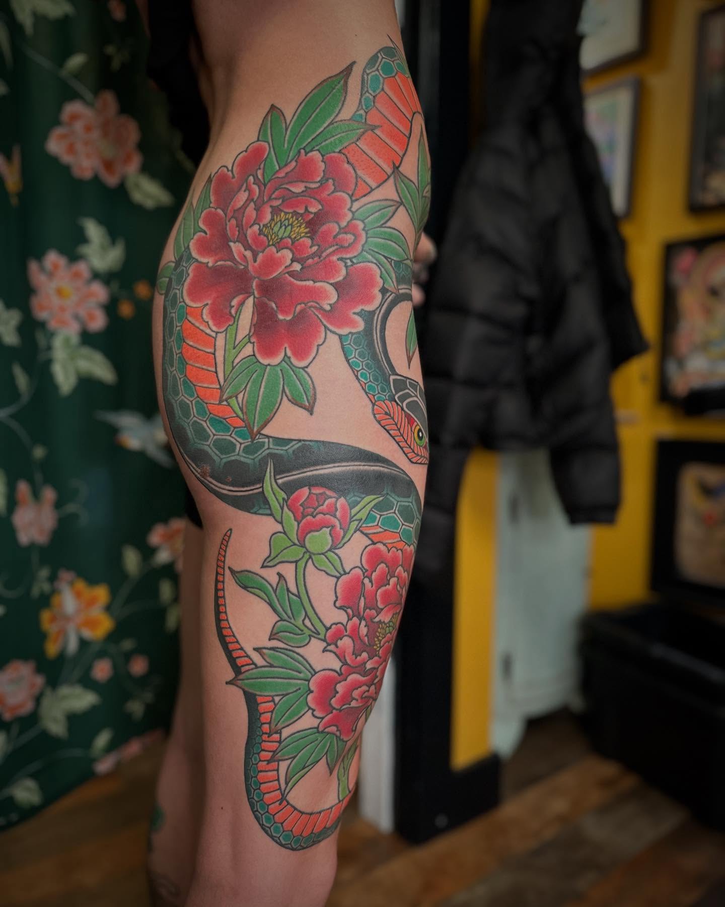 Snake and peony American traditional tattoo on the thigh by Megon Shore, Seattle, Washington