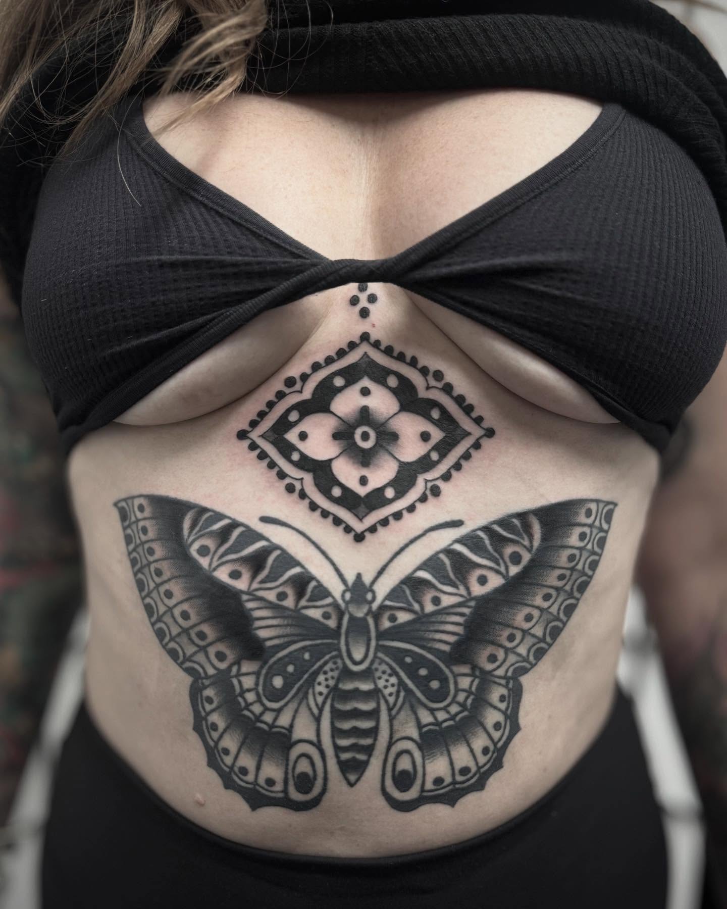Butterfly and geometric pattern geometric tattoo on the torso by Micah Norman, San Francisco, California