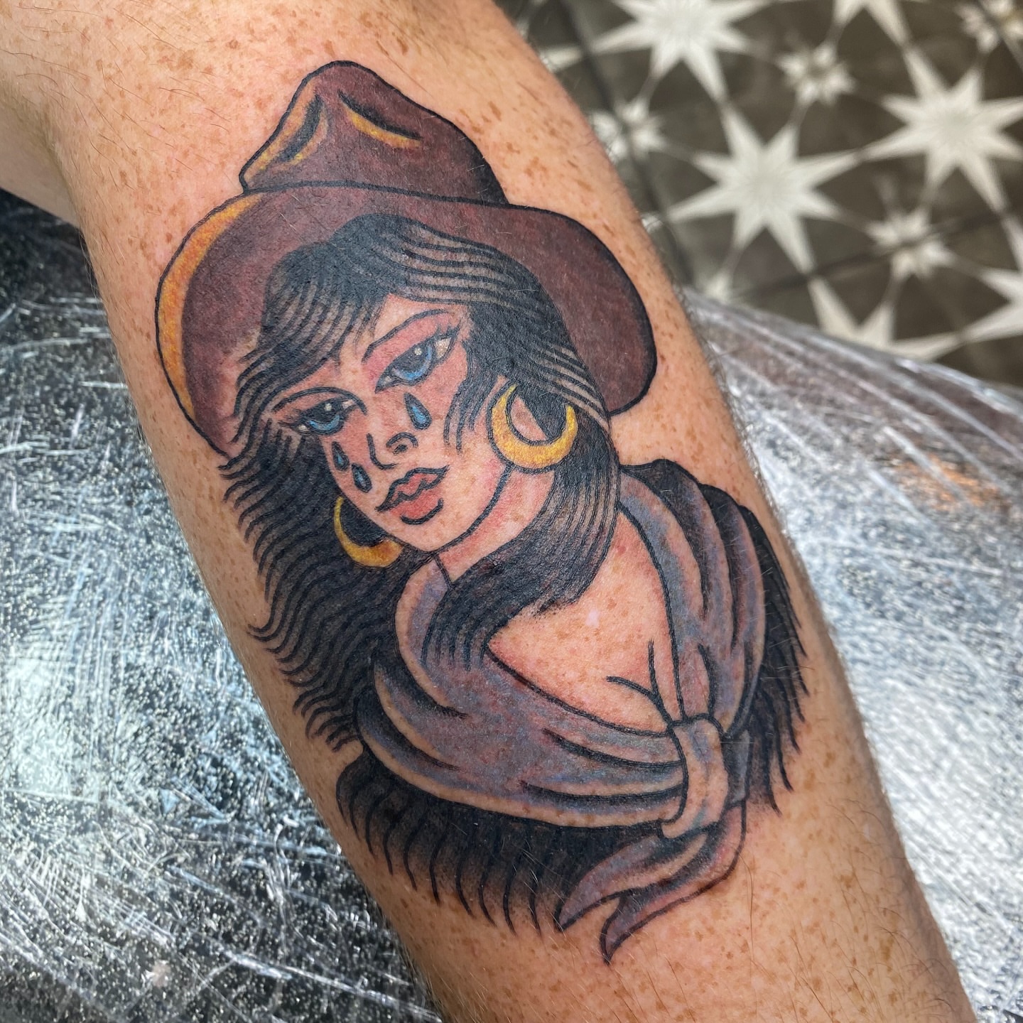 Woman wearing hat American traditional tattoo on the forearm by Mike Tapia