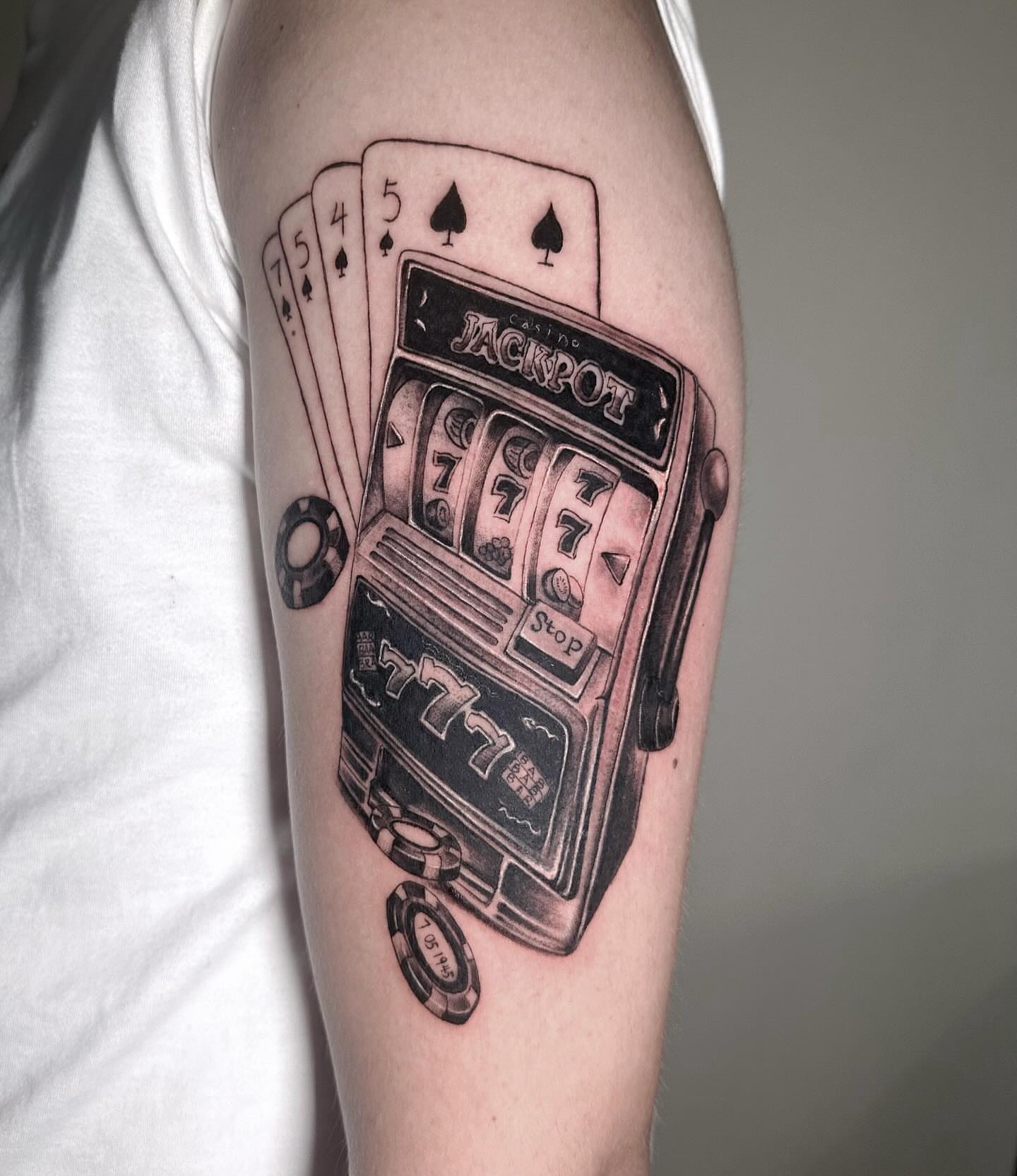 Slot machine and playing cards black and grey tattoo on the forearm by mia's tattoo, Los Angeles, California