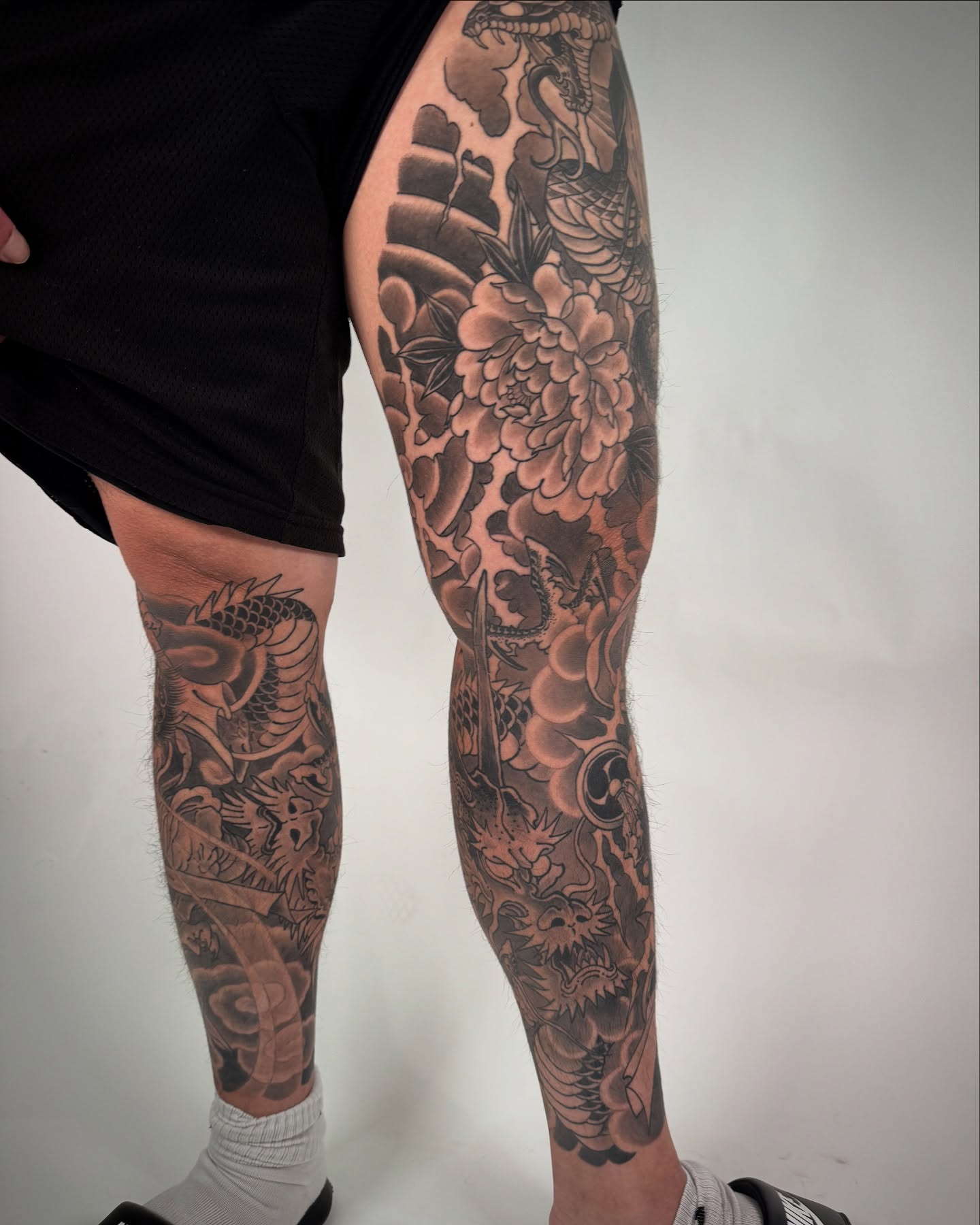 Floral and dragon japanese irezumi tattoo on the leg by Tattooer by Trade Wannabe Artist at Heart