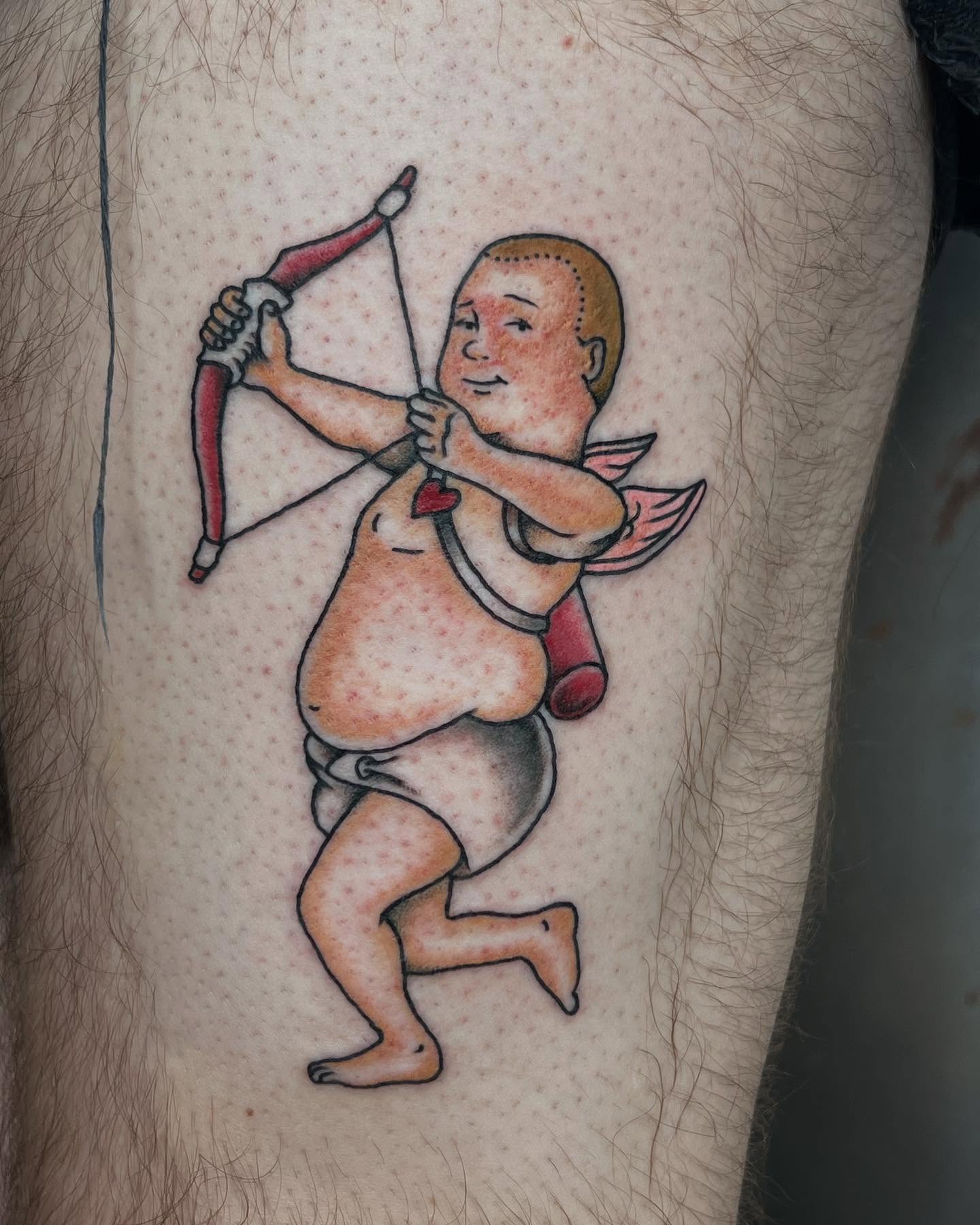Baby archer American traditional tattoo on the thigh by Siërra Nicole, Minneapolis, Minnesota