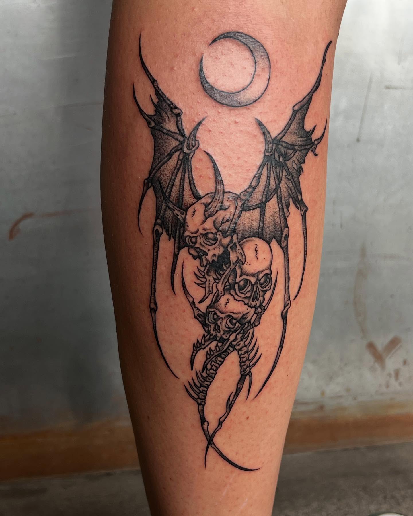 Skulls and wings dark realism tattoo on the forearm by Siërra Nicole, Minneapolis, Minnesota