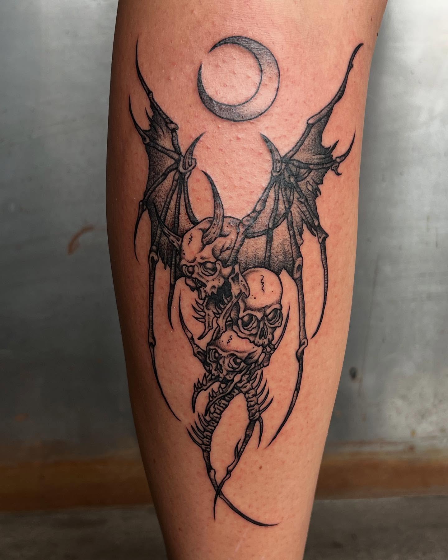 Skulls and bats dark realism tattoo on the forearm by Siërra Nicole, Minneapolis, Minnesota