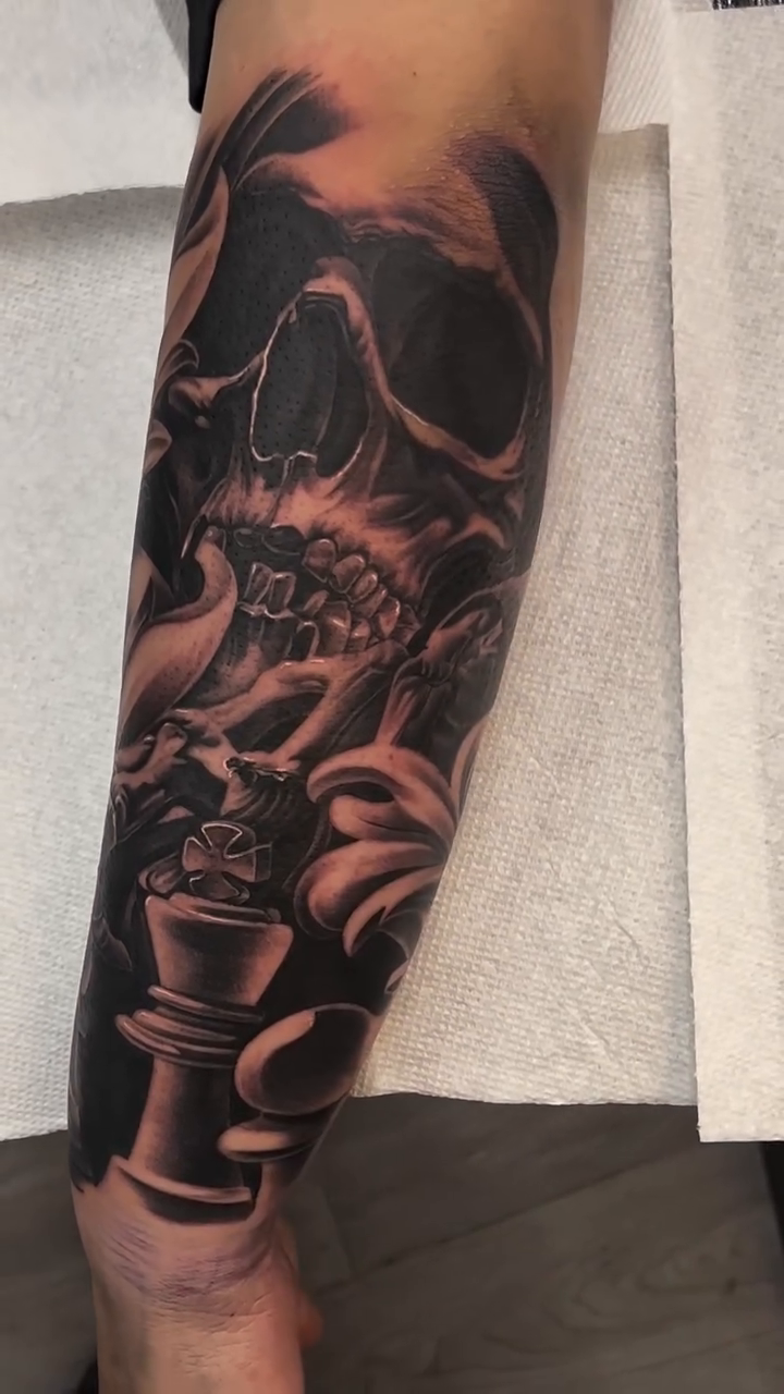 Skull and chess piece dark realism tattoo by Antonio Pavić, Los Angeles, California