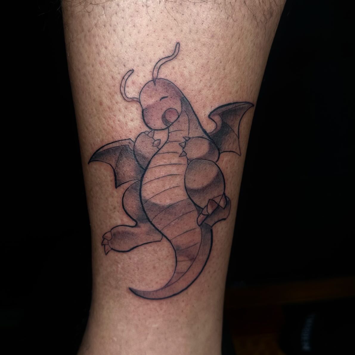 Dragonite black and grey tattoo on the forearm by Jay Morales