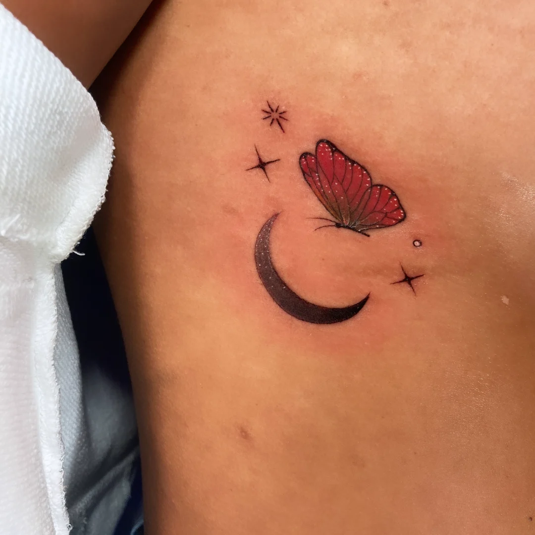 Butterfly and crescent moon dotwork tattoo on the chest by Alvaro